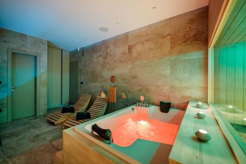 a large bathroom with a tub with chairs in it at Villa Vitrenik, Cista Velika, Makarska-Imotski in Velika Cista