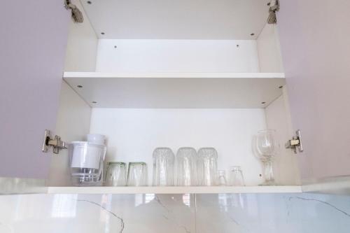 ナイロビにあるLavington View Palace Apartmentsの部屋の中にメガネ入り棚