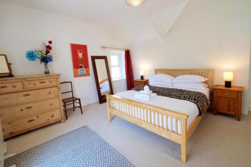 a bedroom with a large bed with a dresser and a dresser at The Retreat - 5 Bedroom House - Horton in Horton