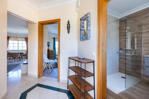 a bathroom with a walkin shower and a glass door at Apartment Presa de Moura in Carvoeiro