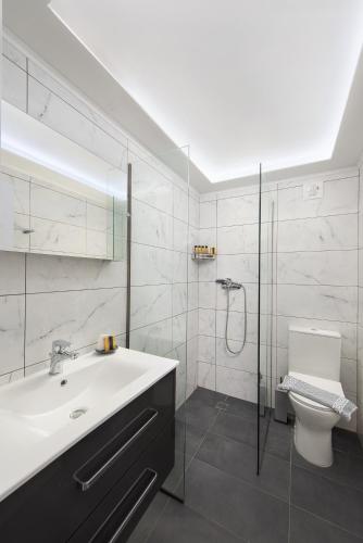 a bathroom with a sink and a shower and a toilet at GR House Eleftheria in Afantou