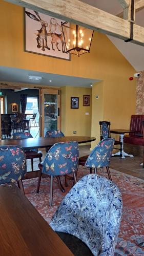 a dining room with blue chairs and a table at Holiday caravan Trough of Bowland in Settle