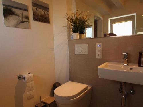 a bathroom with a toilet and a sink at holiday home, Rowy in Rowy