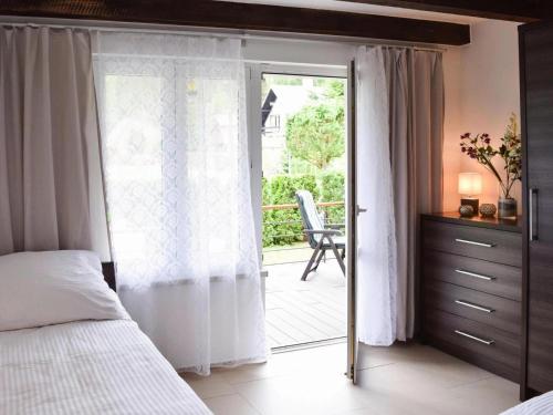 a bedroom with a bed and a sliding glass door at holiday home, Rowy in Rowy
