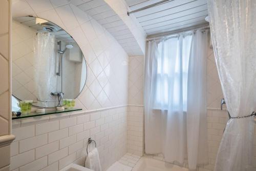 a bathroom with a shower with a shower curtain at Pass the Keys Williams Nest Period Dartmoor Apartment in stunning town setting in Newton Abbot