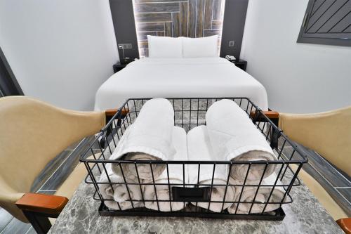 a basket with a person in white socks and a bed at Ytt Hotel in Busan