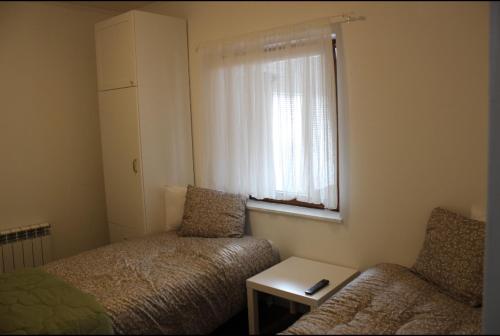 a room with a bed and a couch and a window at Sundsvall lägenhet in Sundsvall