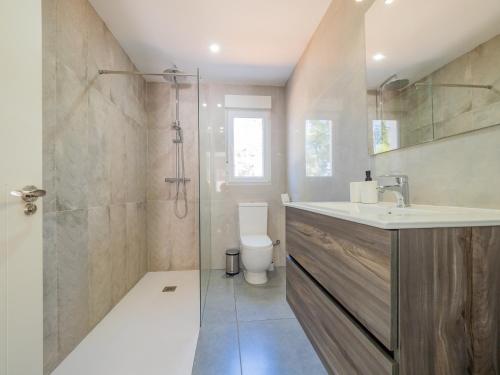 a bathroom with a shower and a sink and a toilet at Cubo's Finca Armonia in Alhaurín el Grande