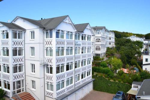 a white apartment building with white balconies on it at Villa Seeblick - Apartment 408 in Sassnitz