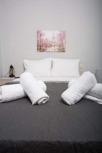 a room with white pillows on a bed at Lux Aprt in a Graphical Village in Kerásia