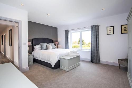 a bedroom with a large bed and a window at 4 Bedroom Barn conversion in Beamish County Durham in Durham