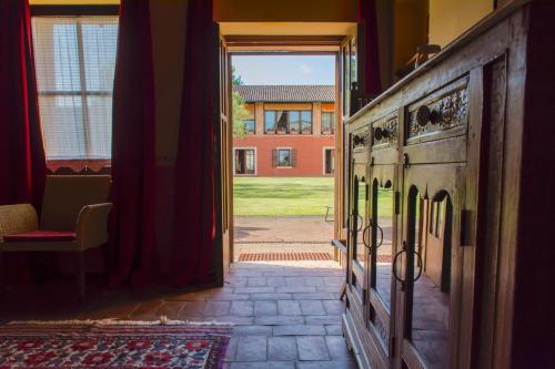 an open door to a room with a view of a building at Musella Winery & Relais in San Martino Buon Albergo