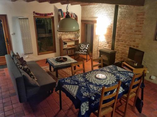 a living room with a couch and a table at Tranquillitude au Moulin Bouquet in La Chapelle-aux-Chasses
