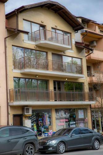 two cars parked in front of a building at Luxury Apartment 'Rich' in Velingrad