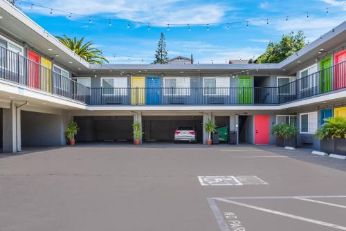an empty parking lot in a building with colorful doors at Signature Inn Oakland in Oakland
