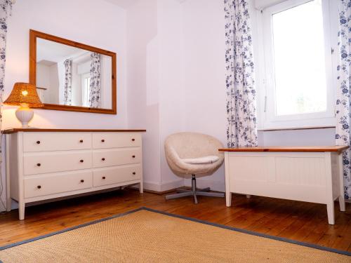 a bedroom with a dresser and a mirror at Gîtes du Hameau Baylesse in Saint-Jean-dʼAigues-Vives