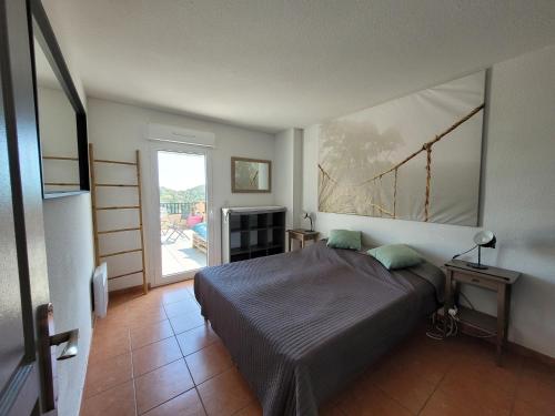 une chambre avec un lit et une grande fenêtre dans l'établissement Rooftop les Issambres, aux Issambres