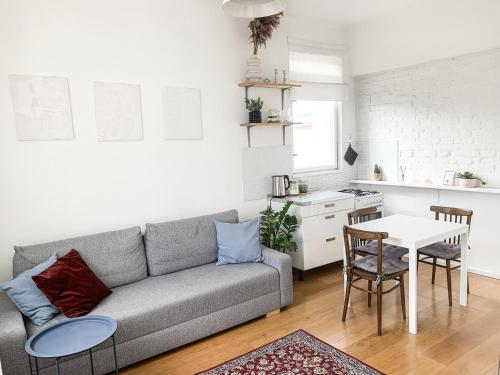 a living room with a couch and a table at City Center Apartments Bratislava in Bratislava