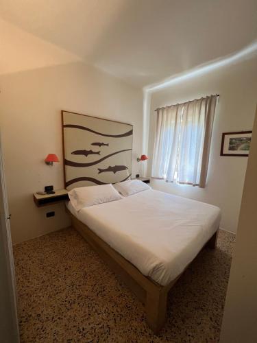Postel nebo postele na pokoji v ubytování Locanda Lorena