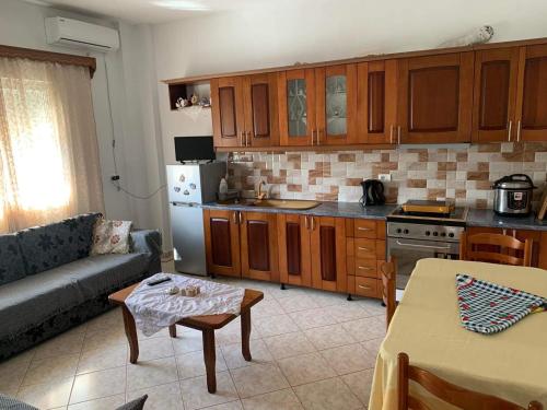 a kitchen with a couch and a table in a room at Nardi Guesthouse in Ksamil