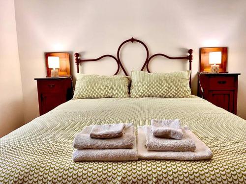 a bedroom with a bed with two towels on it at Casa Il Colle in SantʼUrbano