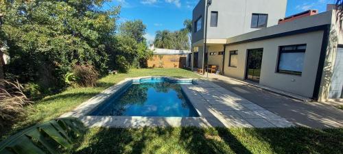 a swimming pool in the yard of a house at Casa Guadalupe in Santo Tomé