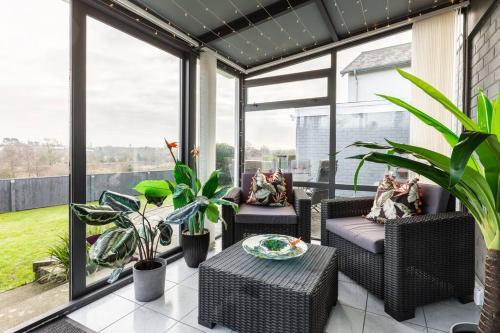a screened in porch with furniture and plants at City home with parking and garden- pet friendly in Chester