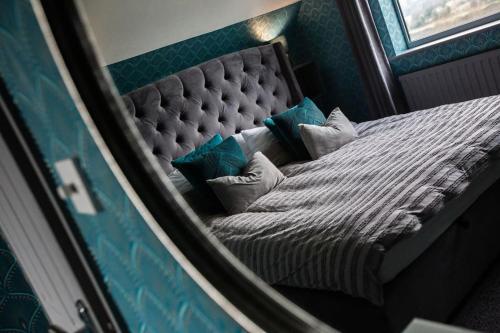 a reflection of a bed with pillows in a mirror at City home with parking and garden- pet friendly in Chester