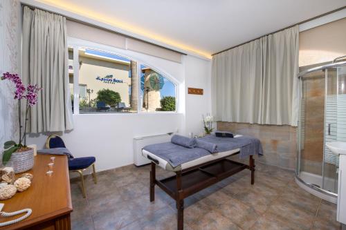 a hospital room with a bed and a shower at Kalyves Beach Hotel in Kalyves