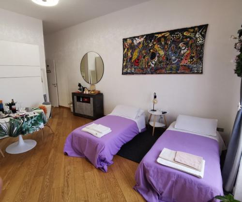 a room with two beds and a mirror at Residenza San Niccolò in Florence