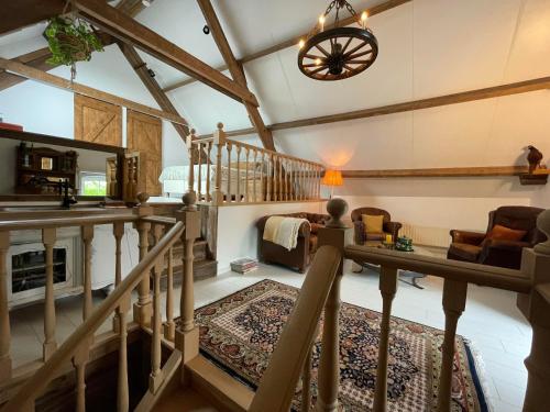 a large room with a staircase and a living room at B&B droom in de polder -DE SALON- luxe appartement met prive-sauna in Arnemuiden
