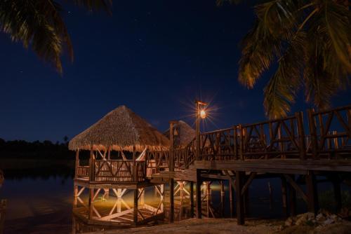 a dock with a light on the water at night at Moriá Eco Lodge in Icaraí