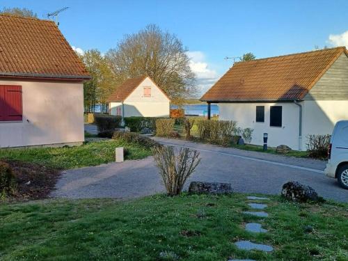 a house and a car parked next to a street at La Maison Bleu du Lac de Céline in Giffaumont
