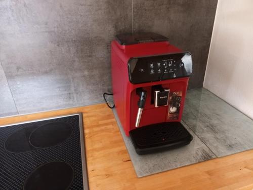a red coffee maker sitting on top of a counter at Ferienhaus 1893 Frielendorf in Frielendorf