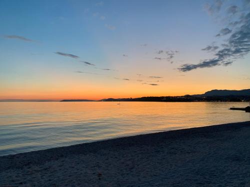 a sunset on a beach with the ocean at Sweet Corner in Split