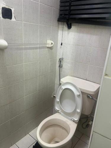 a bathroom with a toilet with the lid up at Nova Room 1 - Private Room in a Condo in Abuja
