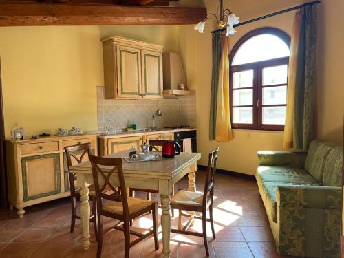 a kitchen with a table and chairs and a couch at Villa Borri in Casciana Terme