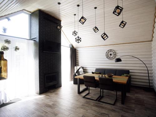 a dining room with a table and a fireplace at Телячі Ніжності in Umanʼ
