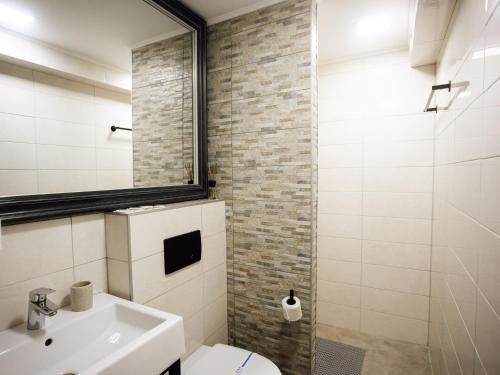 a bathroom with a white toilet and a sink at Телячі Ніжності in Umanʼ