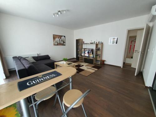 a living room with a table and a couch at Park West Apartment - Free Parking in Budapest