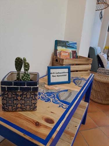 a table with a cactus and a sign on it at La Casa sulla Spiaggia in Marzamemi