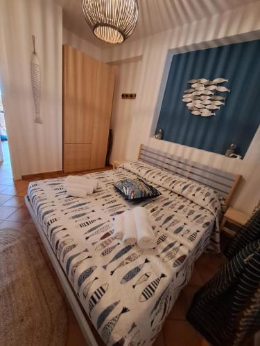 a bed with a white comforter and towels on it at La Casa sulla Spiaggia in Marzamemi