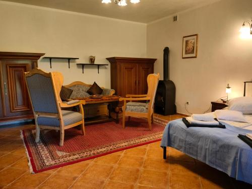 a bedroom with two beds and a desk and chairs at Siedlisko Sabinowo in Węgorzewo