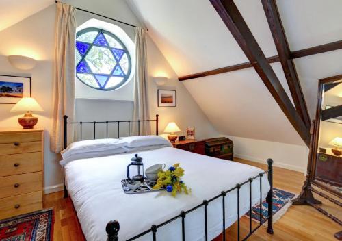 a bedroom with a bed with a window at The Old Chapel in Hindolveston