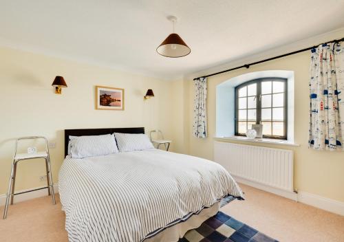 a bedroom with a bed and a window at Flat 8 The Granary in Wells next the Sea