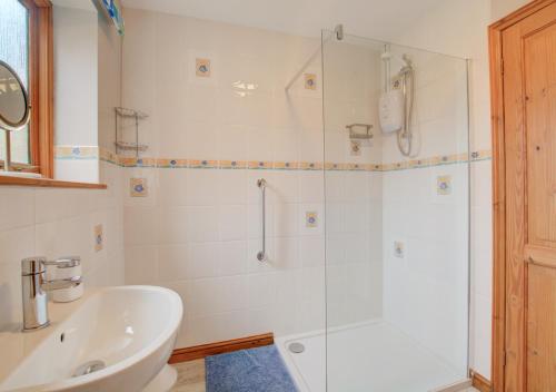 a bathroom with a shower and a sink at The Hideaway in Witton