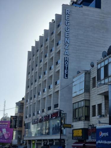 a building with a sign on the side of it at Reggenza Hotel Downtown Ramallah in Ramallah