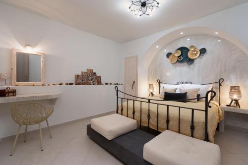a bedroom with a bed and a sink and a table at Marilias Apartment in Kamari