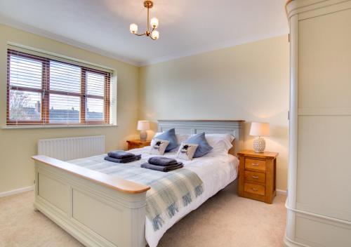 a bedroom with a large bed and a window at 1 Street Farm Cottages in Bodham