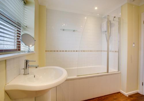 a bathroom with a sink and a shower at 1 Street Farm Cottages in Bodham